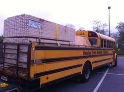 One bus has been converted to a 16-passenger vehicle with a truck bed for hauling cargo