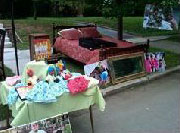 Still to be sold: an antique bow-front oak-and-glass china cabinet and a cherry spindle bed